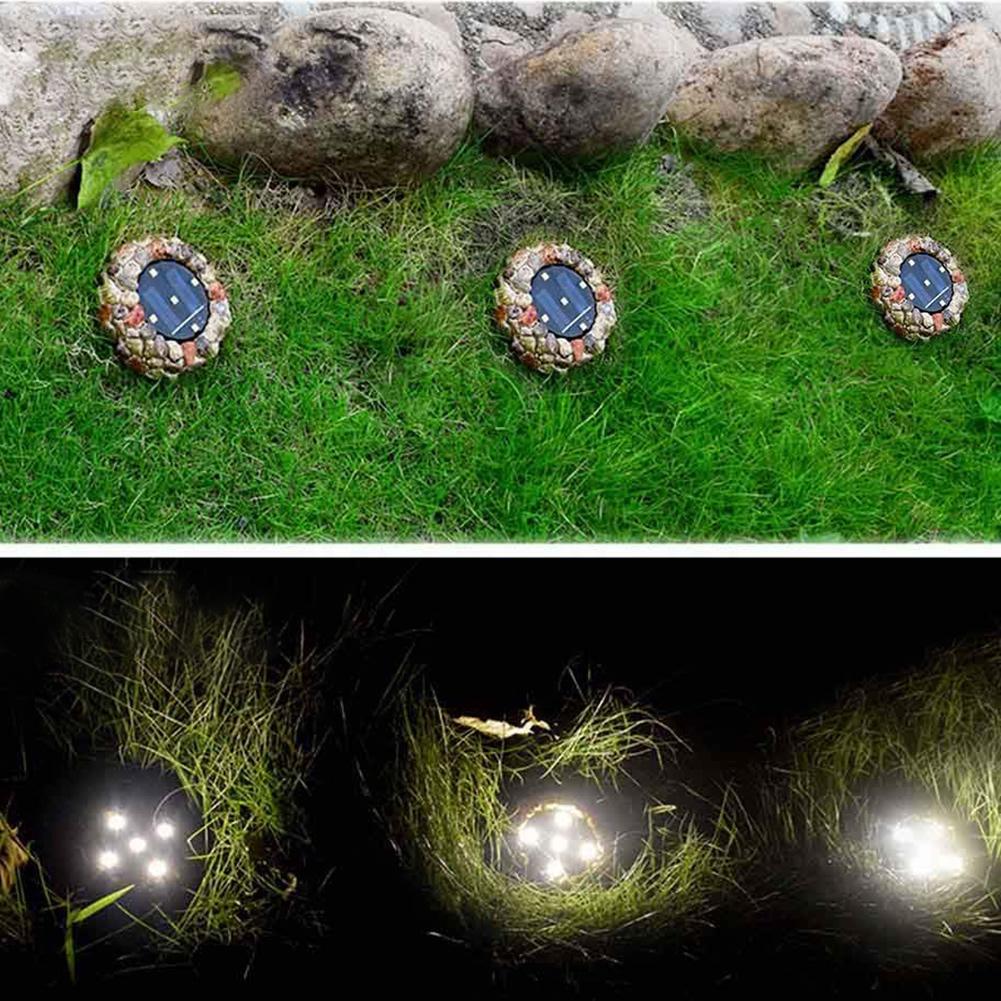 Kobblestensformad solcellsdriven LED-lampa i keramik och plast för trädgårdsrabatter